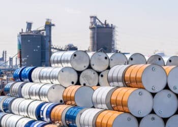 Industry oil chemical metal barrels stacked up in waste yard of tank and container, Kawasaki city near Tokyo Japan
