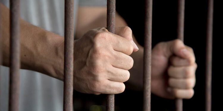 Hands of the prisoner in jail