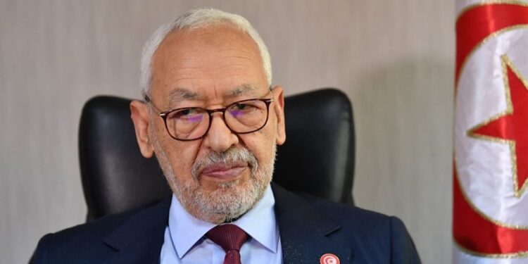 (FILES) In this file photo taken on March 31, 2022 Rached Ghannouchi, head of the Islamist-inspired Ennahdha party, looks on during an interview with AFP at his office in Tunis. A Tunisian court on May 15, 2023 sentenced Rached Ghannouchi, one of the main opponents of Tunisian President Kais Saied, to one year in prison on terrorism-related charges, local media reported. (Photo by FETHI BELAID / AFP)