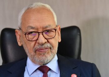 (FILES) In this file photo taken on March 31, 2022 Rached Ghannouchi, head of the Islamist-inspired Ennahdha party, looks on during an interview with AFP at his office in Tunis. A Tunisian court on May 15, 2023 sentenced Rached Ghannouchi, one of the main opponents of Tunisian President Kais Saied, to one year in prison on terrorism-related charges, local media reported. (Photo by FETHI BELAID / AFP)